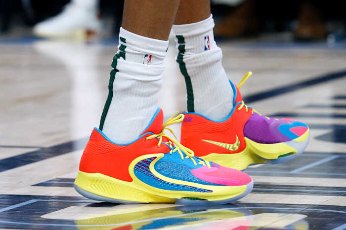 View of Giannis Antetokounmpo's red and yellow Nike shoes.